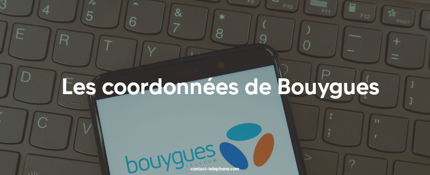 Téléphone mobile, affichant le logo de Bouygues Telecom, posé sur un clavier d'ordinateur.